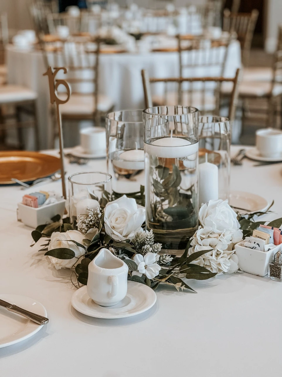 Reception tables styled with luxury wedding floral rentals in DFW, showcasing silk centerpieces that create a refined, cohesive look without the unpredictability of fresh flowers.