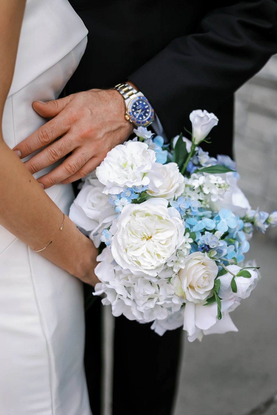 Bride holding a silk wedding bouquet from Sherpa’s luxury wedding floral rentals in DFW, featuring soft neutrals and greenery that look flawless in person and in photos.